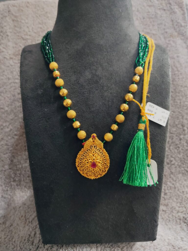 gold wax beads necklace with green beads